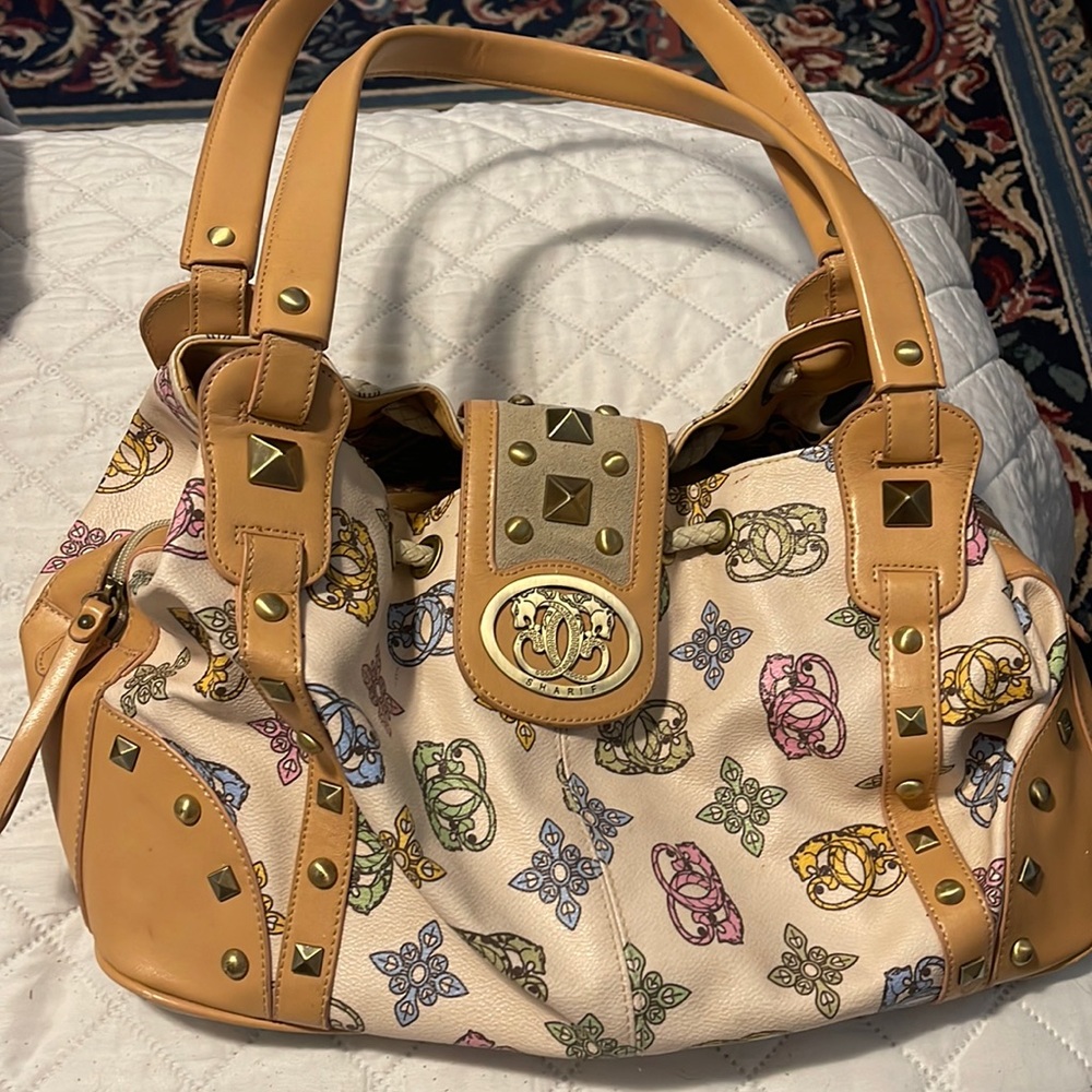 3 fold patterned Sharif 1827 buckle purse with animal printer interior.